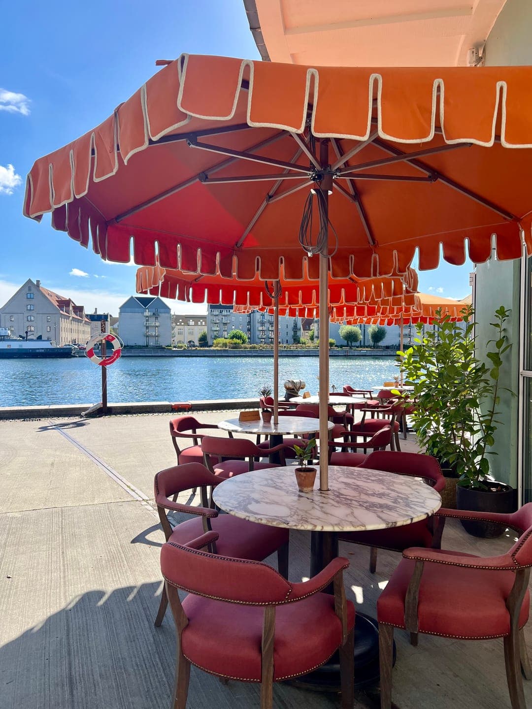 Orange umbrellas on a harbourside terrace in Copenhagen